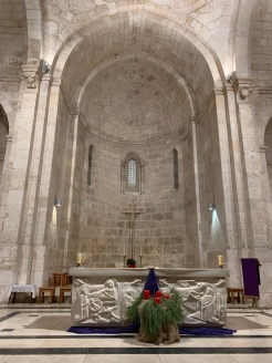 Altar area of church with high vaulted ceiling