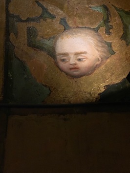 Painting of an angel face looking down